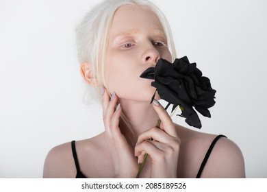 Pretty Albino Model With Black Lips Holding Rose Isolated On White