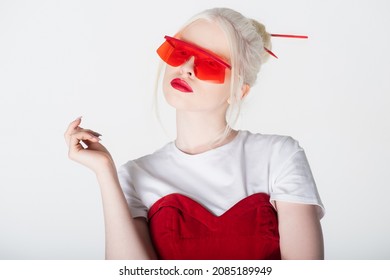 Pretty Albino Model In Red Sunglasses And Hair Sticks Isolated On White