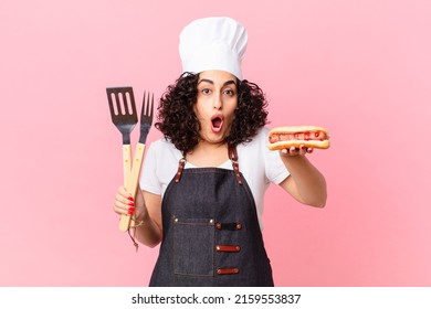 pretty arab woman barbecue chef preparing hot dogs