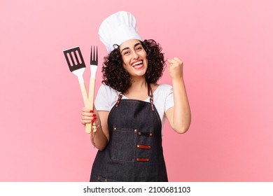 Pretty Arab Woman Feeling Shocked,laughing And Celebrating Success. Barbeque Chef Concept