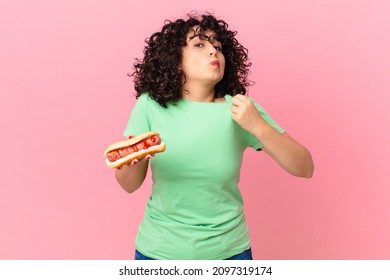 Pretty Arab Woman Looking Arrogant, Successful, Positive And Proud And Holding A Hot Dog