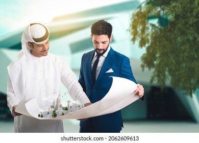 Pretty architect is explaining to Arab builders the plan of construction. The foreman pointing at the prototype building. - Shutterstock ID 2062609613
