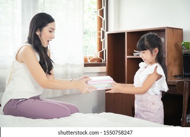 Pretty Asian Daughter Suprise Her Mother With Gift Box On Mothers Day. A Good Relationships.