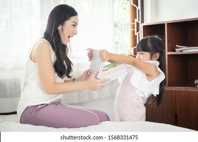 Pretty Asian Daughter Suprise Her Mother With Gift Box On Mothers Day. A Good Relationships.