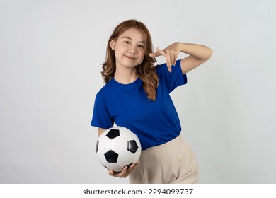 Pretty Asian female soccer fans celebrating on isolated white background female sports fan Asian girl in blue t-shirt holding soccer ball posing on white background - Powered by Shutterstock