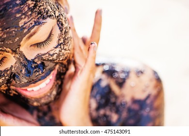 Pretty Asian Girl Applying Chocolate Face Mask