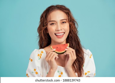 Pretty Asian Girl Eating Watermelon On A Blue Background