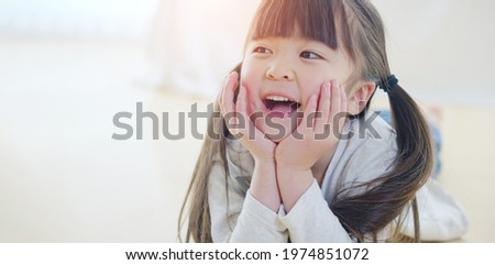 Pretty asian little girl lying on the floor.