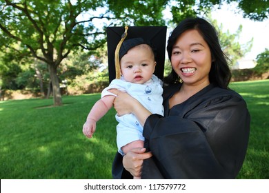 A pretty asian woman with baby boy at graduation ceremony
