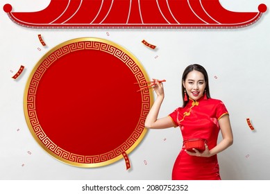 Pretty Asian woman in traditional red Qipao dress holding plastic food box and chopsticks in oriental style background, foreign text translation as Chinese new year