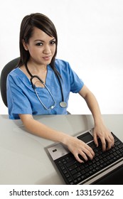 Pretty Attractive Asian Filipino Nurse Working On Laptop