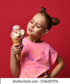 Pretty Baby Girl Kid Hold Big Ice Cream In Waffles Cone With Raspberry Happy Smiling Ready To Eat On Red Background