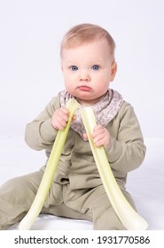 Pretty Baby Holds A Stem Of Celery, White Background