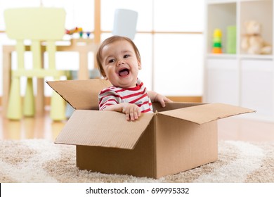 Pretty Baby Infant Boy Sitting Inside Box In New House