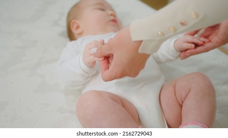 Pretty Baby Laying Down On The Bed Relax Time Her Mother Playing With Hands Concept Of Maternity And Childhood