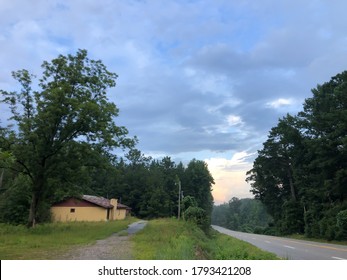 Pretty Backroad Along Trees And Forest In Southeast Alabama. Beautiful Cloudy Sky After A Rainstorm.