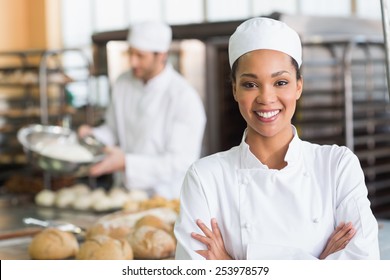 Pretty Baker Smiling At Camera In The Kitchen Of The Bakery