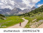 pretty beautiful senior woman riding her electric mountain bike in the Fanes high Valley, part of Fanes-Sennes-Braies nature park in the Alta Badia Dolomites,  South Tirol and Trentino, Italy