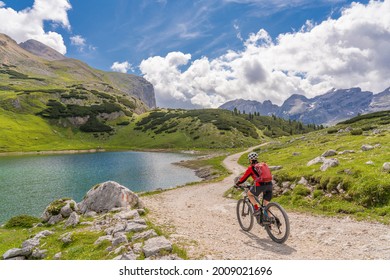 pretty beautiful senior woman riding her electric mountain bike in the Fanes high Valley, part of Fanes-Sennes-Braies nature park in the Alta Badia Dolomites,  South Tirol and Trentino, Italy - Powered by Shutterstock