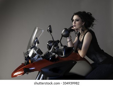 Pretty Biker Chick Leaning On Large Red Motorcycle