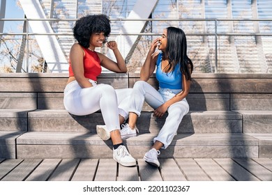 Pretty Black Female Friends Talking And Laughing In The City. One Of Them Has Cool Afro Hair.