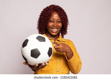pretty black lady holding a soccer ball - Shutterstock ID 2182421081