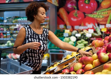 Pretty Black Woman Choosing Fruits In A Grocery Store