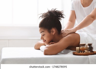 Pretty Black Woman Enjoying Relaxing Body Massage With Aromatherapy At Spa, Copy Space