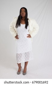 Pretty Black Woman In A  White Fur Jacket, Looking  Thoughtful