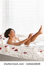 Pretty Black Young Woman Shaving Her Sexy Legs While Taking Bath At Home, Free Space