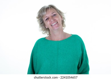 pretty blond senior happy woman smiling in green top sweater on white background - Powered by Shutterstock