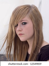 Pretty Blond Teen Girl Looks Into The Camera Looking Almost Gothic