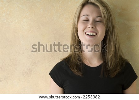 pretty blond woman, caught in a happy moment,eyes closed, smiling