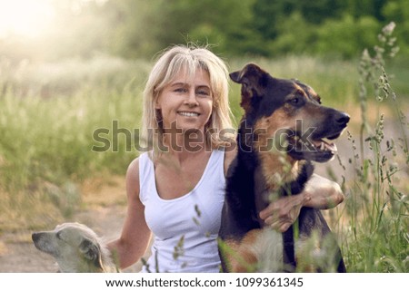 Image, Stock Photo Pretty blond woman with her two dogs