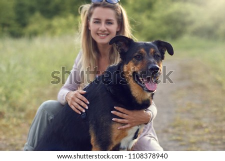 Similar – Attractive smiling blond woman with her two dogs