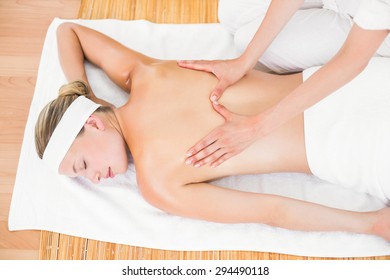 Pretty blonde enjoying a massage at the health spa - Shutterstock ID 294490118