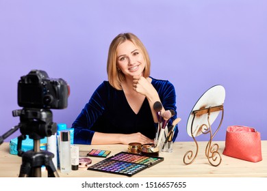 Pretty Blonde Female Make Up Artist Showing New Make Up Product Line, Sharing Beauty Tips With Followers, Making Video For Her Blog, Smiling Broadly In Camera. Social Networks Concept.