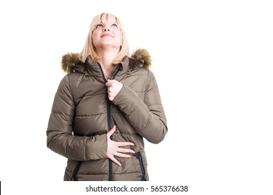 Pretty Blonde Girl Zipping Winter Warm Jacket And Looking Up Isolated On White Background With Copy Text Space