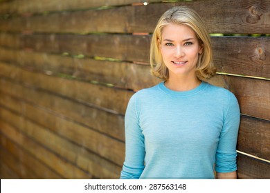 Pretty blonde single woman portrait outdoors nice teeth and hair