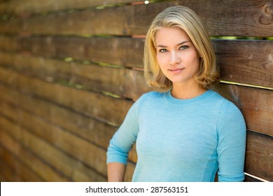 Pretty blonde single woman portrait outdoors