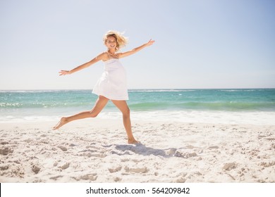 Pretty Blonde Woman Jumping On The Beach