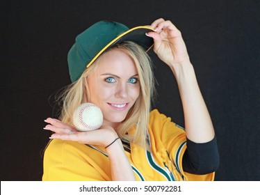 A pretty blonde woman ready to play some baseball or softball. - Powered by Shutterstock