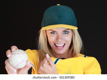 A pretty blonde woman ready to play some baseball or softball. - Powered by Shutterstock