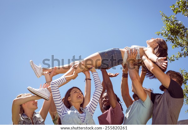 Pretty brunette\
crowd surfing on a sunny\
day