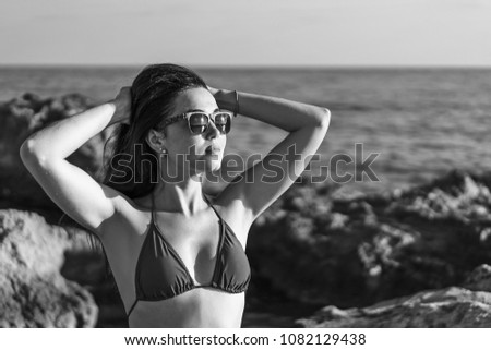 Pretty brunette girl relaxing at the sea