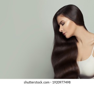 Pretty Brunette Model Woman With Long Healthy Brown Hair On White Background. Haircare And Facial Treatment Concept