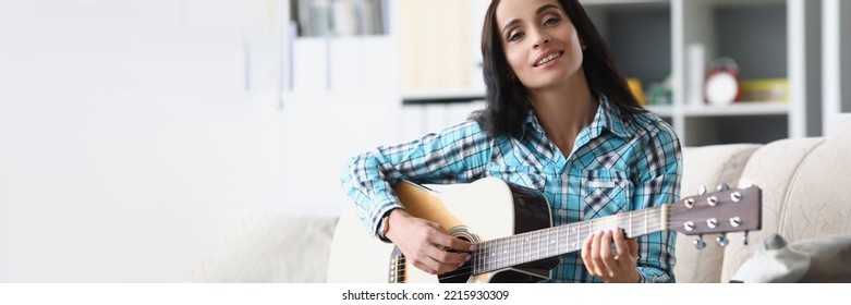 Pretty Brunette Woman Playing On Guitar In Living Room, Female Spend Free Time To Learn New Hobby