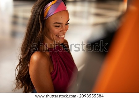 Pretty brunette woman withdraving cash. Young woman using ATM machine	