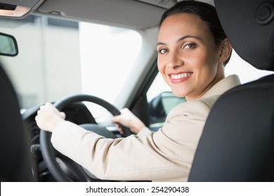 Pretty businesswoman smiling and driving in her car - Shutterstock ID 254290438