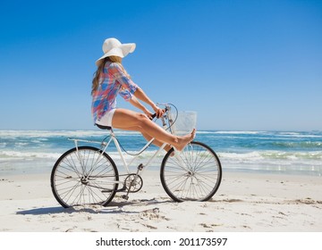 Pretty Carefree Blonde On A Bike Ride At The Beach On A Sunny Day